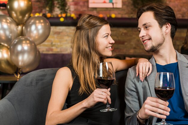 Young beautiful happy couple enjoying their date at bar