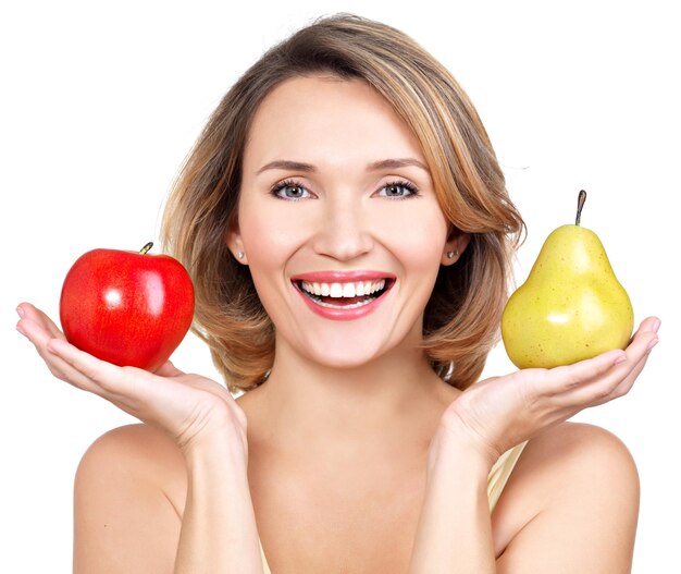 Young beautiful happy woman holds the apple and pear - isolated on white.