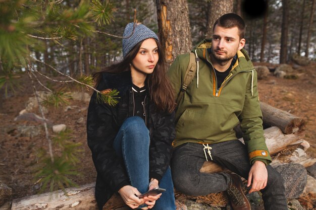 Young beautiful hipster man and woman in love traveling together in wild nature