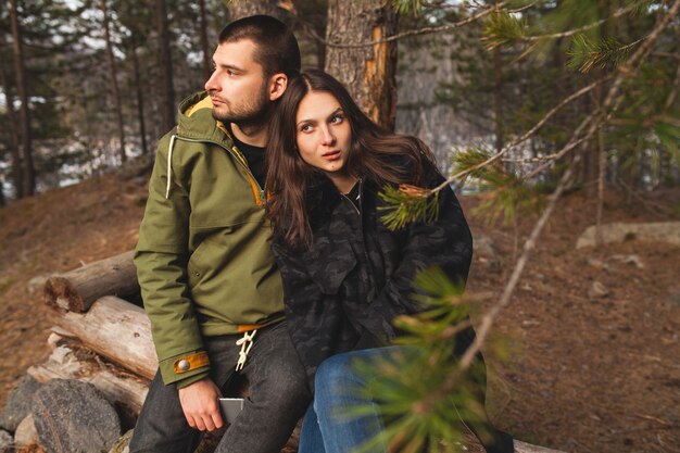 Young beautiful hipster man and woman in love traveling together in wild nature