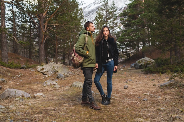 Young beautiful hipster man and woman in love traveling together in wild nature