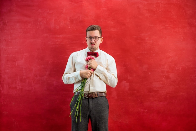 Free photo young beautiful man with flowers