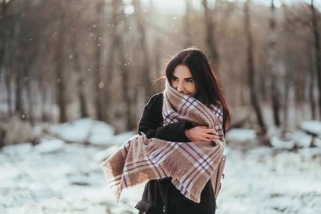 Young beautiful model posing in winter forest. stylish fashion portrait