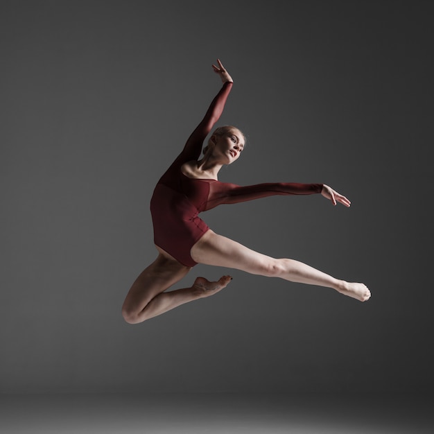 Young beautiful modern style dancer jumping