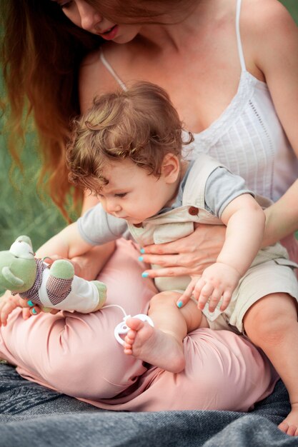 Young beautiful mother sitting with her little son