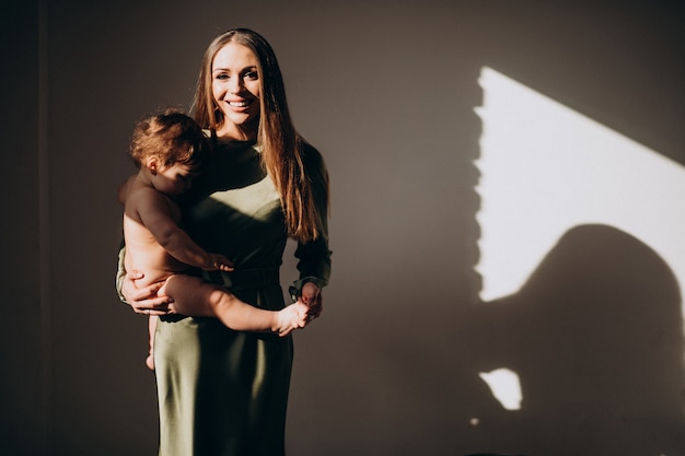 Young beautiful mother with her small child,practicing breast feeding