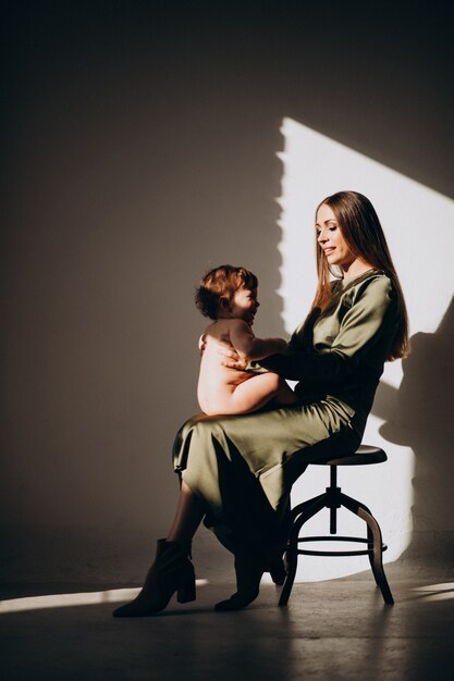 Young beautiful mother with her small child,practicing breast feeding