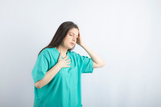 Young beautiful nurse feeling sick.