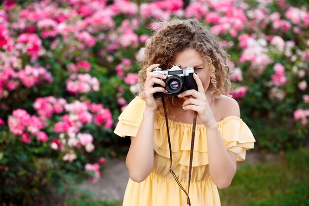 Young beautiful photographer walking around city.