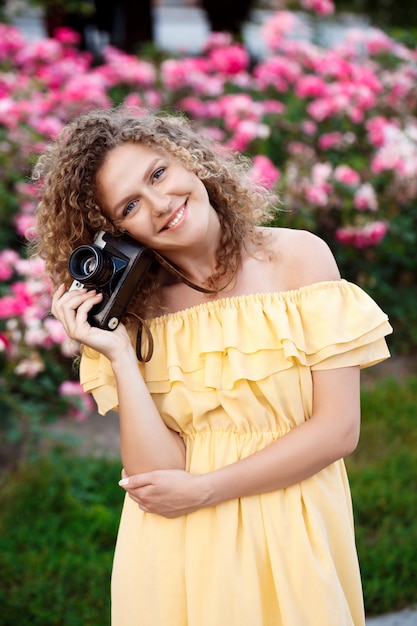 Free photo young beautiful photographer walking around city.