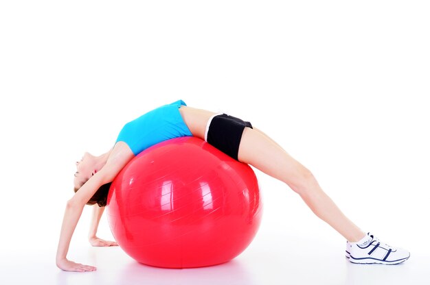Young beautiful pretty girl doing physical exercises with fitball