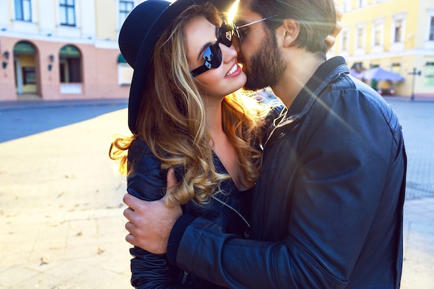 Young beautiful sensual blonde girl kissing her handsome stylish boyfriend.