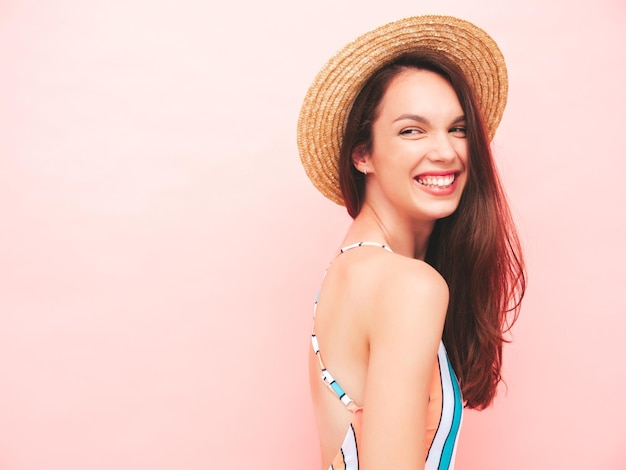 Young beautiful sexy smiling  hipster woman in posing in studio.Trendy model in colourful summer swimwear bathing suit.Positive model going crazy.Happy and cheerful