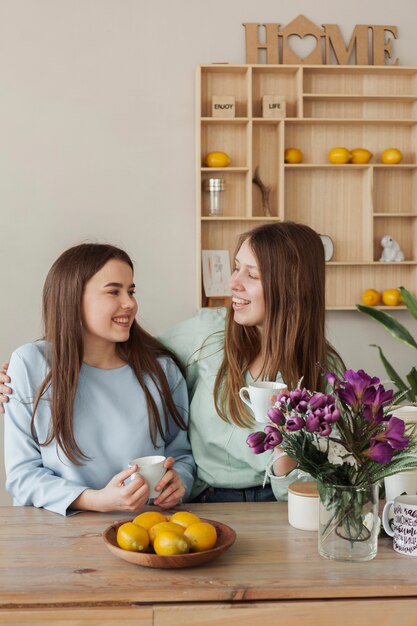 Young beautiful sisters smiling at each other