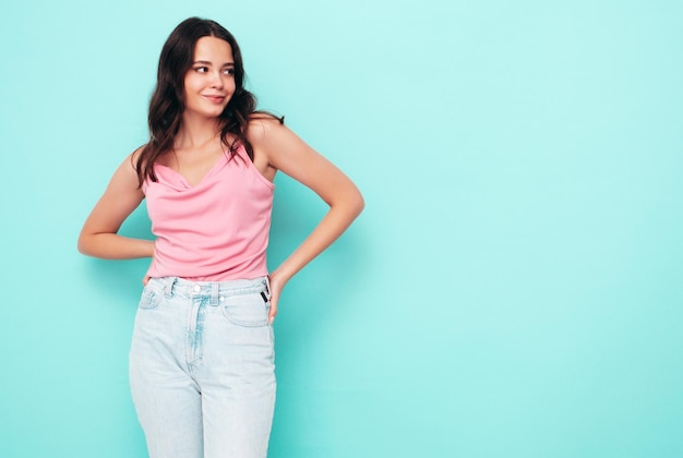 Young beautiful smiling female in trendy summer clothes Sexy carefree woman posing in studio Positive model having fun indoors