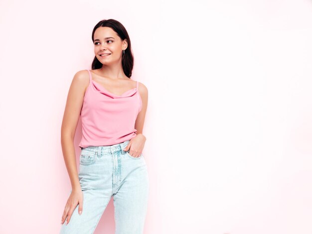 Young beautiful smiling female in trendy summer clothes Sexy carefree woman posing in studio Positive model having fun indoors