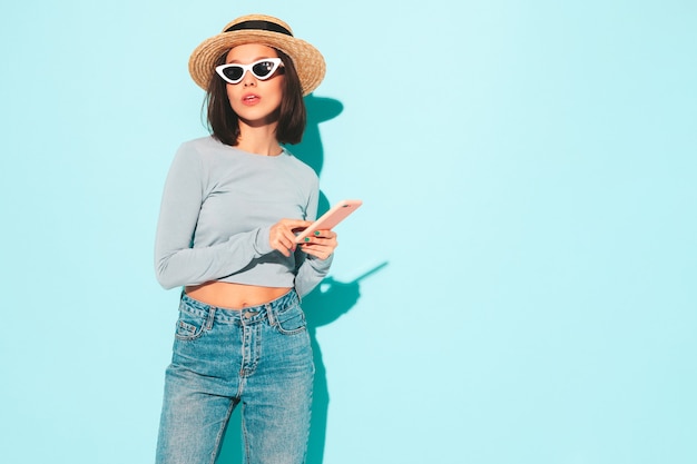 Young beautiful smiling female in trendy summer hipster clothes