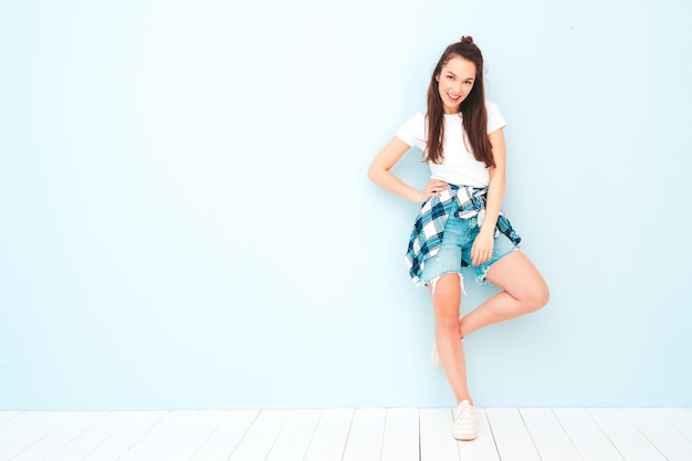 Young beautiful smiling female in trendy summer hipster clothes