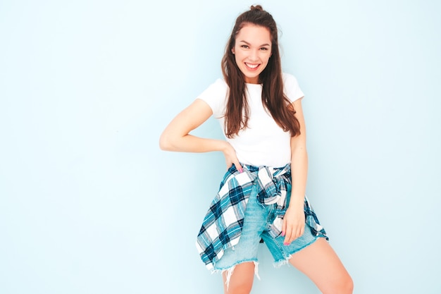 Young beautiful smiling female in trendy summer hipster clothes