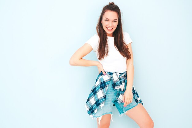 Young beautiful smiling female in trendy summer hipster clothes