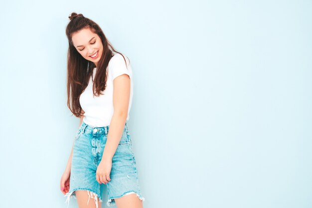 Young beautiful smiling female in trendy summer hipster clothes