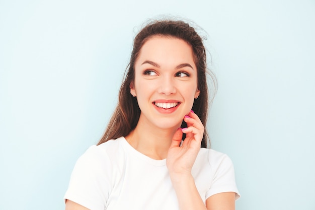 Young beautiful smiling female in trendy summer hipster clothes