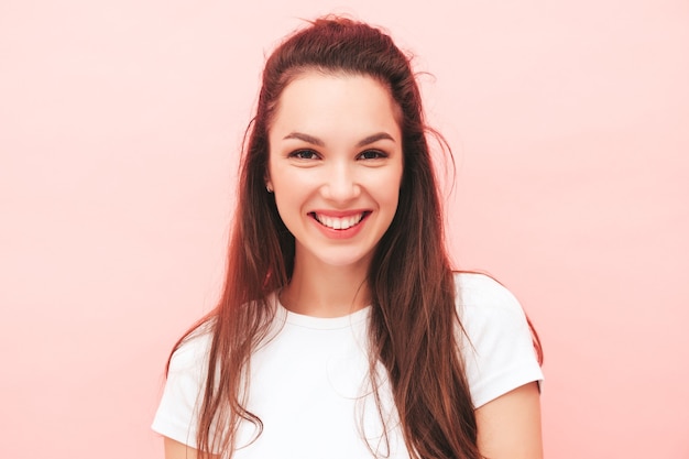 Young beautiful smiling female in trendy summer hipster clothes