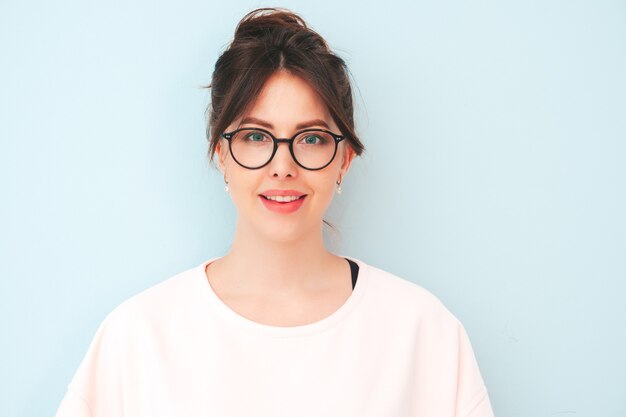 Young beautiful smiling female in trendy summer hipster clothes