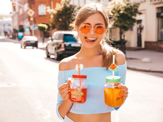 Young beautiful smiling hipster woman in sunglasses.