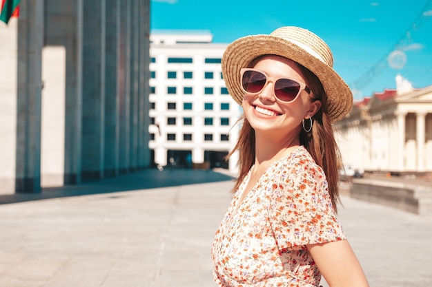 Young beautiful smiling hipster woman in trendy summer clothes Sexy carefree woman posing on the street background at sunset Positive model outdoors Cheerful and happy in sunglasses