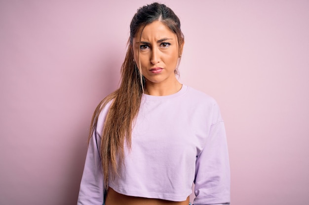 Free photo young beautiful sport woman wearing sweatshirt over pink isolated background skeptic and nervous frowning upset because of problem negative person