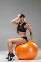 Free photo the young, beautiful, sports girl doing exercises on a fitball