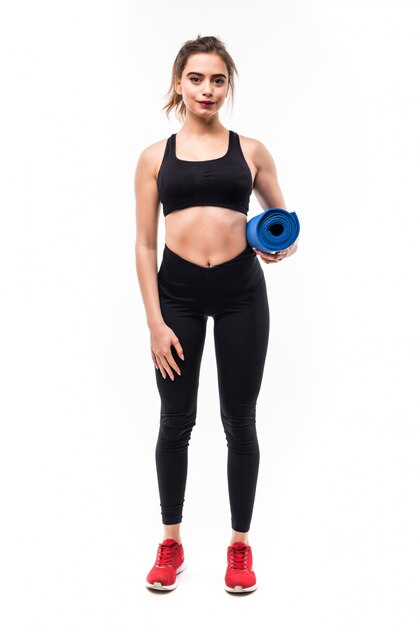 Young beautiful sportswoman yoga concept with blue mat.