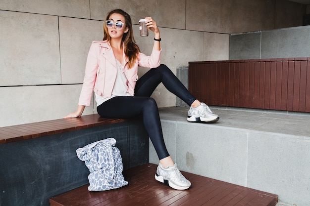 Young beautiful stylish hipster woman in pink leather jacket