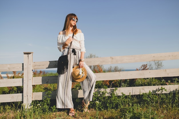 Young beautiful stylish woman posing outdoors