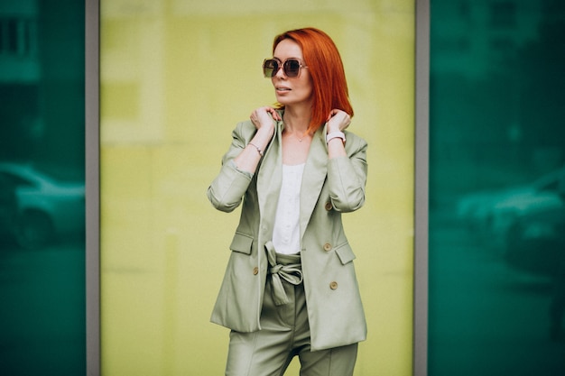 Free photo young beautiful successful woman in green suit