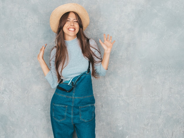 Young beautiful surprised woman looking  with hands in the air. Trendy girl in casual summer clothes. 