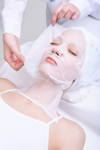 Young beautiful woman in the beauty cosmetic salon - indoors