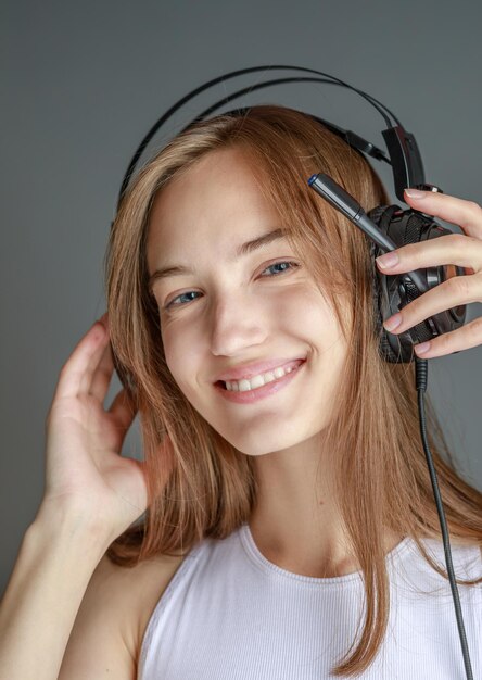 Young beautiful woman in bright outfit enjoying the music at home