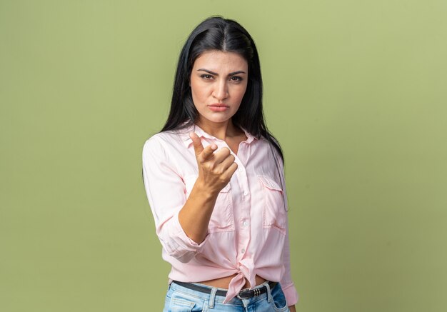 Young beautiful woman in casual clothes looking with serious face being displeased