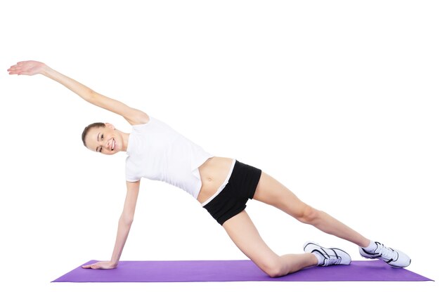 Young beautiful woman doing aerobic exercises - isolated on white