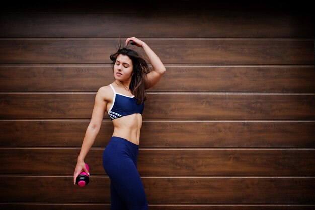 Young beautiful woman doing exercises outdoor training process