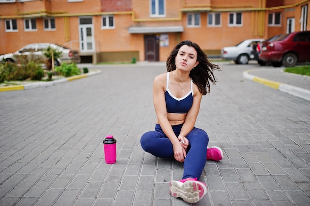 Young beautiful woman doing exercises outdoor training process