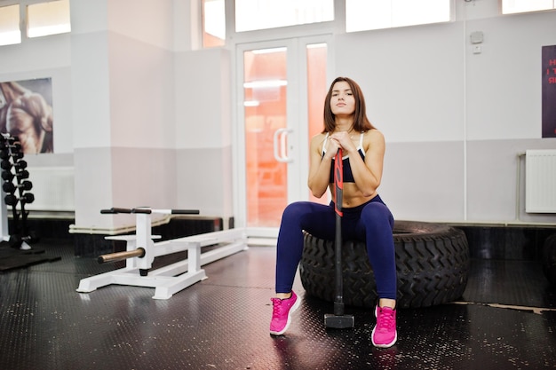 Young beautiful woman doing exercises and working hard in gym and enjoying her training process