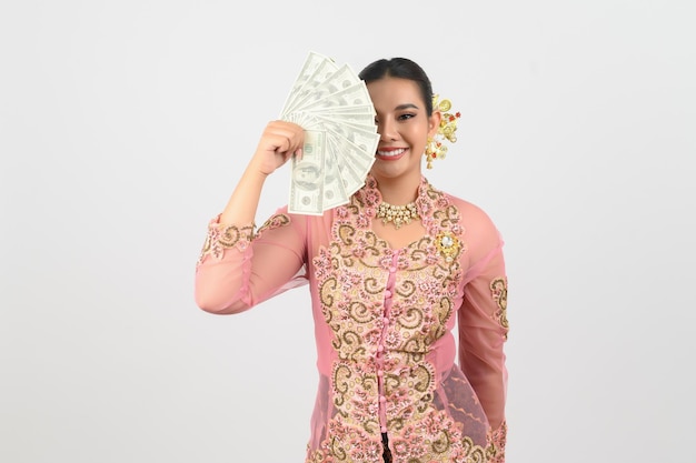 Free photo young beautiful woman dress up in local culture in southern region pose with banknote