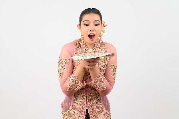 Young beautiful woman dress up in local culture in southern region pose with banknote