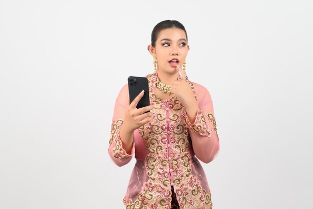 Young beautiful woman dress up in local culture in southern region pose with smartphone