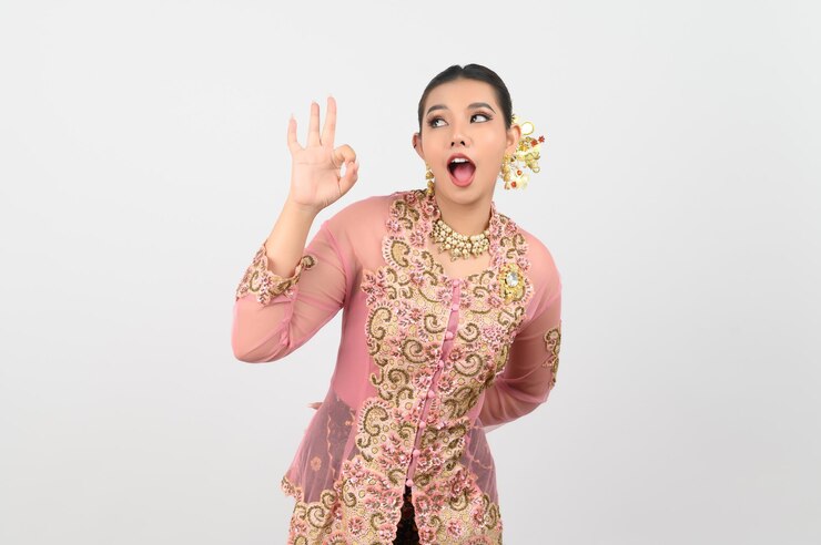 Free Photo young beautiful woman dress up in local culture in southern region with ok posture