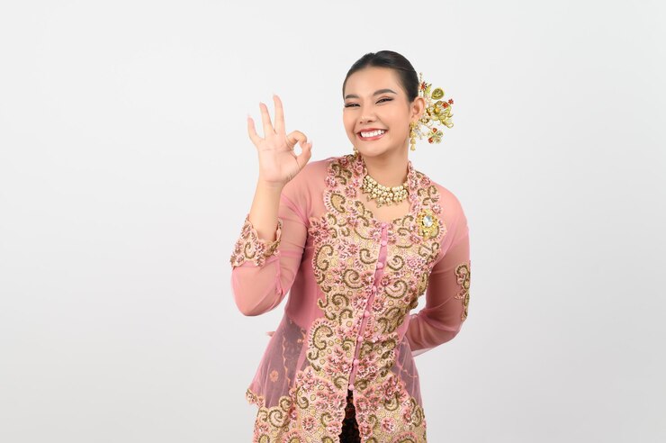 Free Photo young beautiful woman dress up in local culture in southern region with ok posture