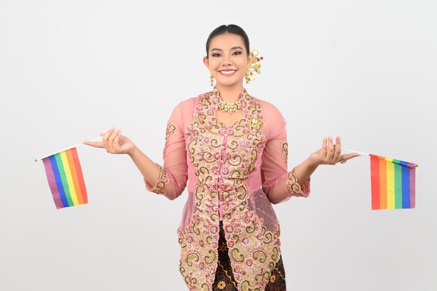 Young beautiful woman dress up in local culture in southern region with rainbow flag